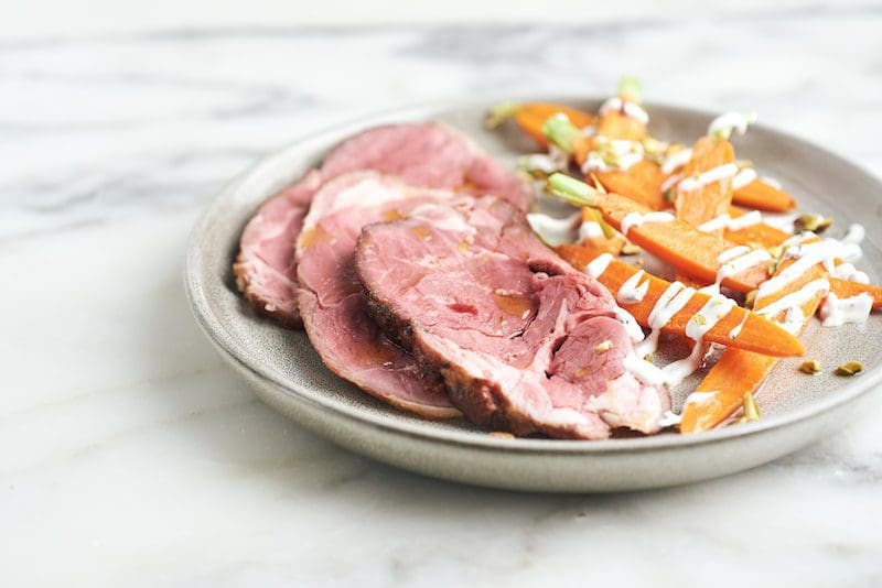 sliced ham and carrots on a plate easter dinner - East End Taste Magazine