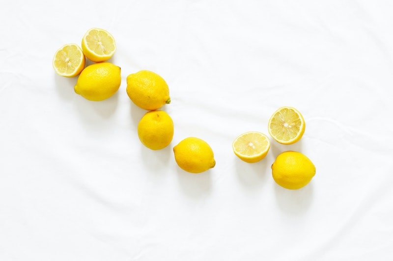 halved lemons on white table