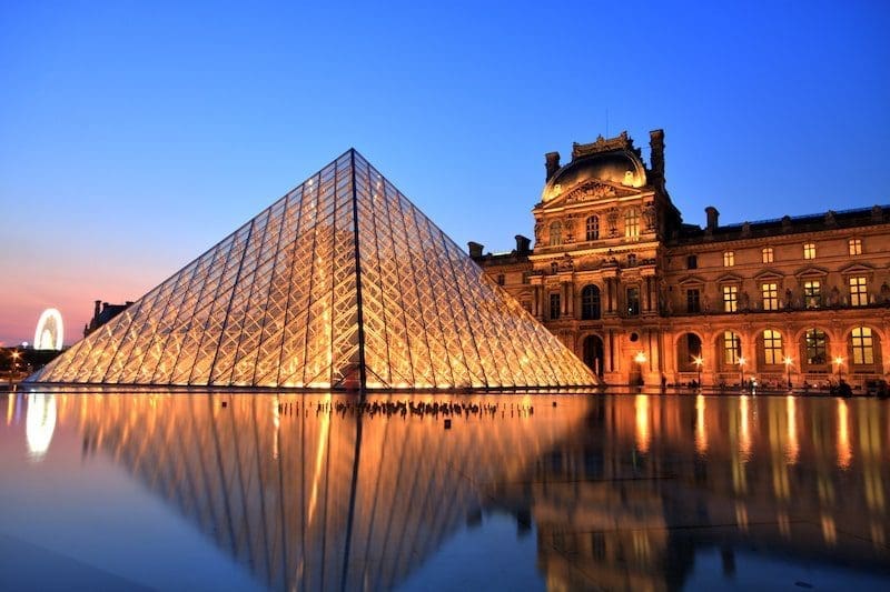 paris the louvre at night sunset sustainable travel