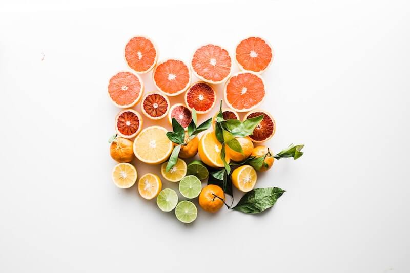 sliced lemons grapefruit limes white background