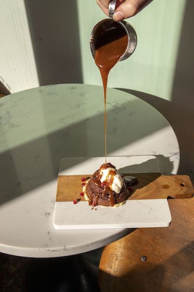 sticky toffee pudding at booting restaurant in nyc chelsea neighborhood dessert pour