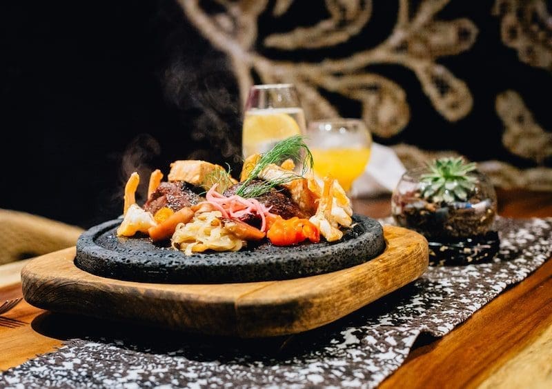 dinner dining fine cuisine Spanish cuisine on a hot stone plate evening