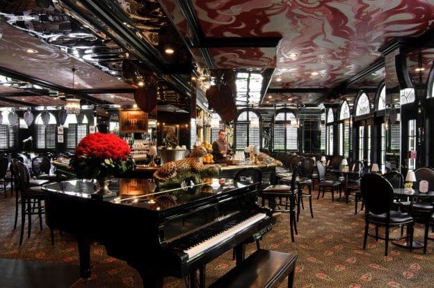 grand piano in restaurant bar with leopard red flowers black decor