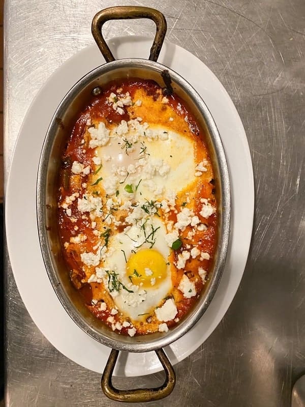 egg scramble with cheese and herbs in a pan egg yolk