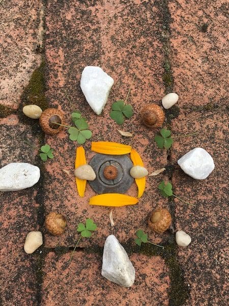 art stone four leaf clover acorn arrangement on brick path