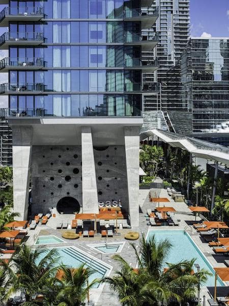 outdoor pool at miami hotel orange chairs umbrellas