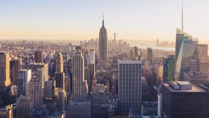 new york city skyline businesses tall buildings sunrise - East End Taste Magazine