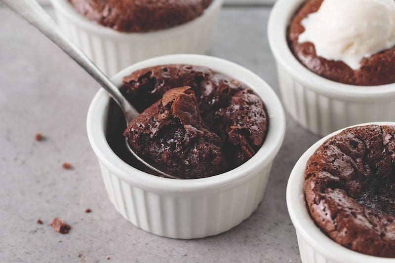 omaha steaks chocolate souffles ramekins with a spoon - East End Taste Magazine