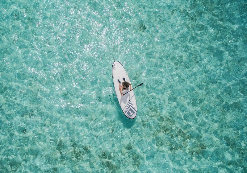paddle boarding aerial view warm weather caribbean