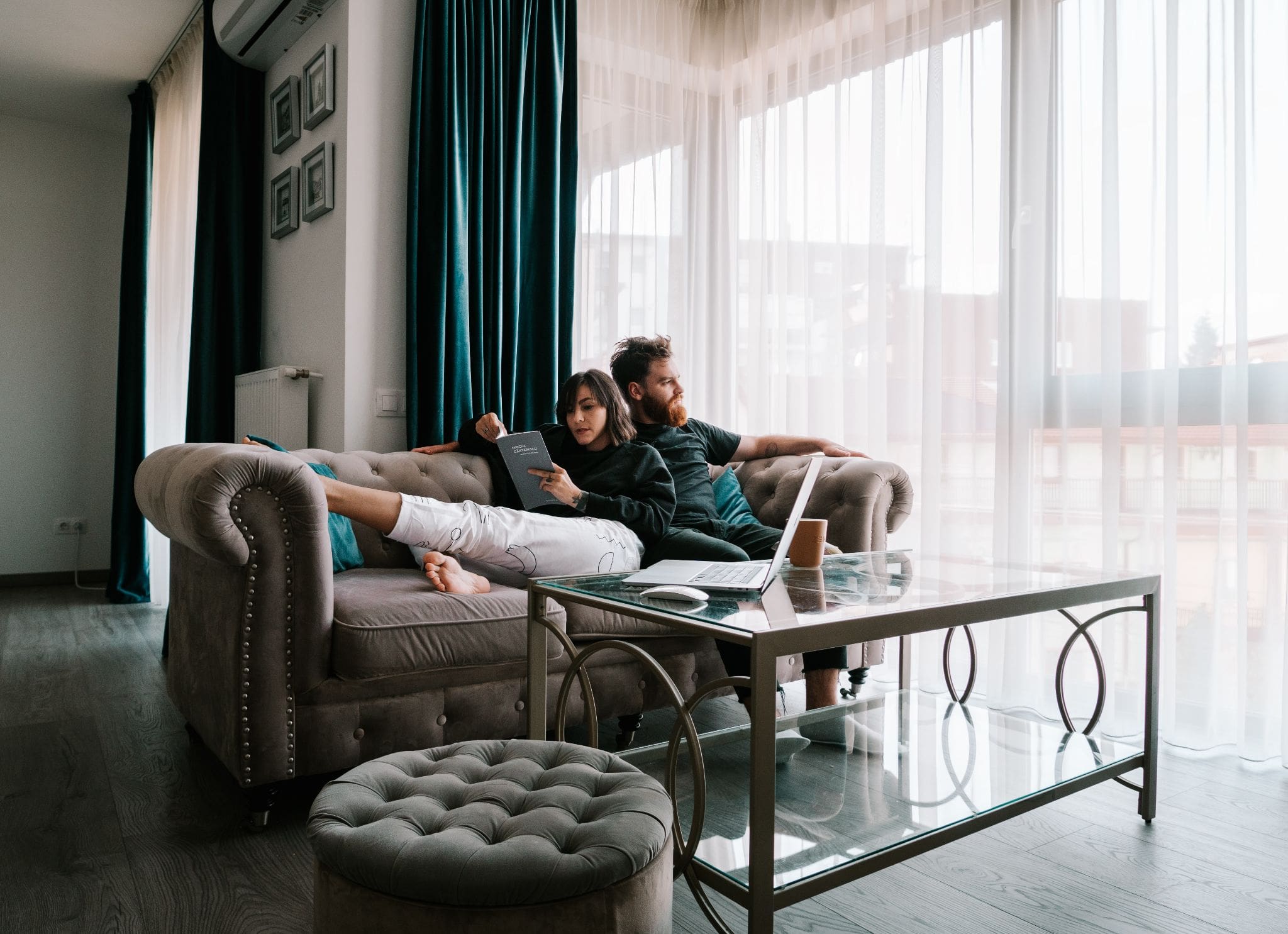 couple sitting on couch in condo coop