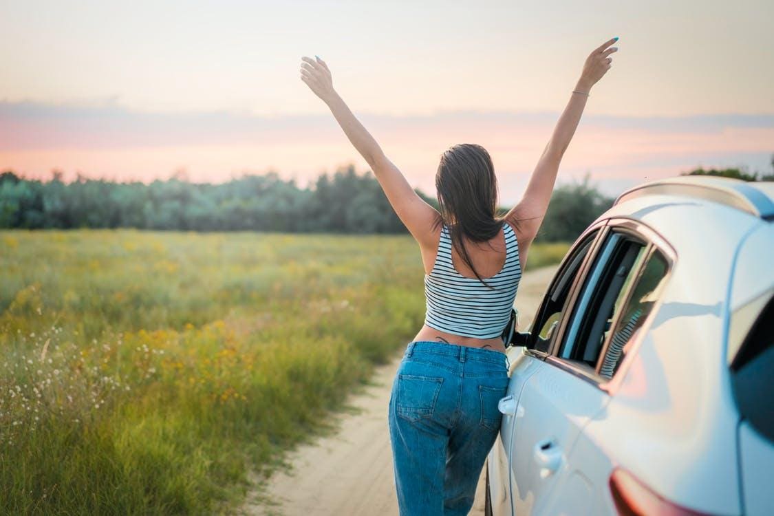 woman excited about road trip open space freedom travel
