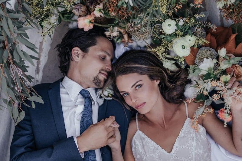 young wedding couple with brown hair flowers
