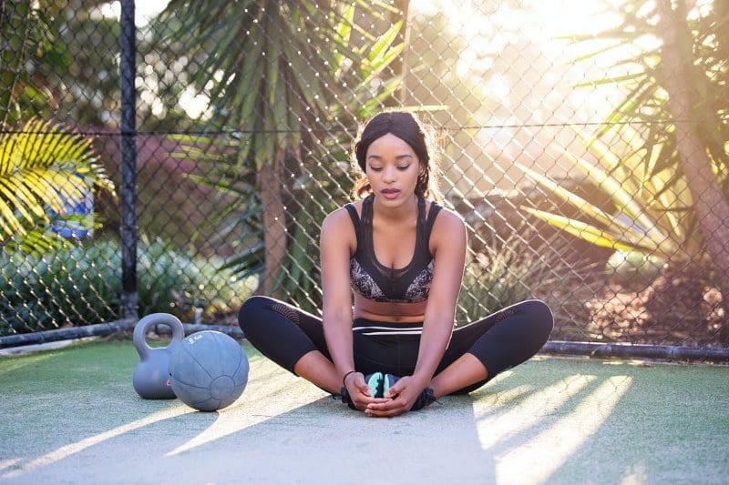 woman doing outdoor fitness with kettle bells
