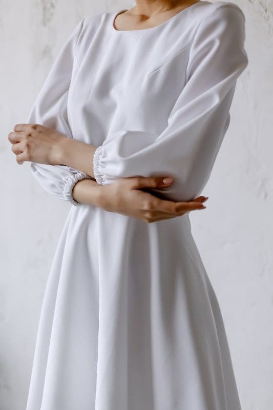 white style dress woman with folded arms