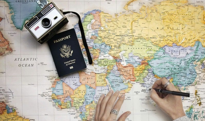 international travel tips map with camera passport