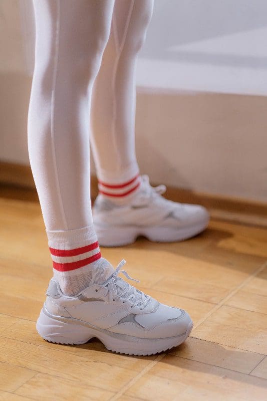 white hosiery with white sneakers and red striped socks