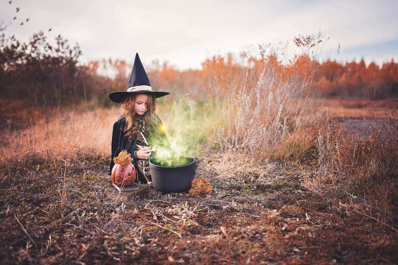 paige cody young girl in witch costume outside