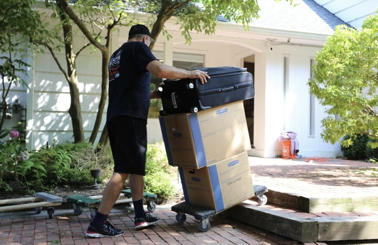 Man moving boxes into moving truck