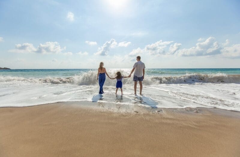 family looking at the ocean family vacation beach