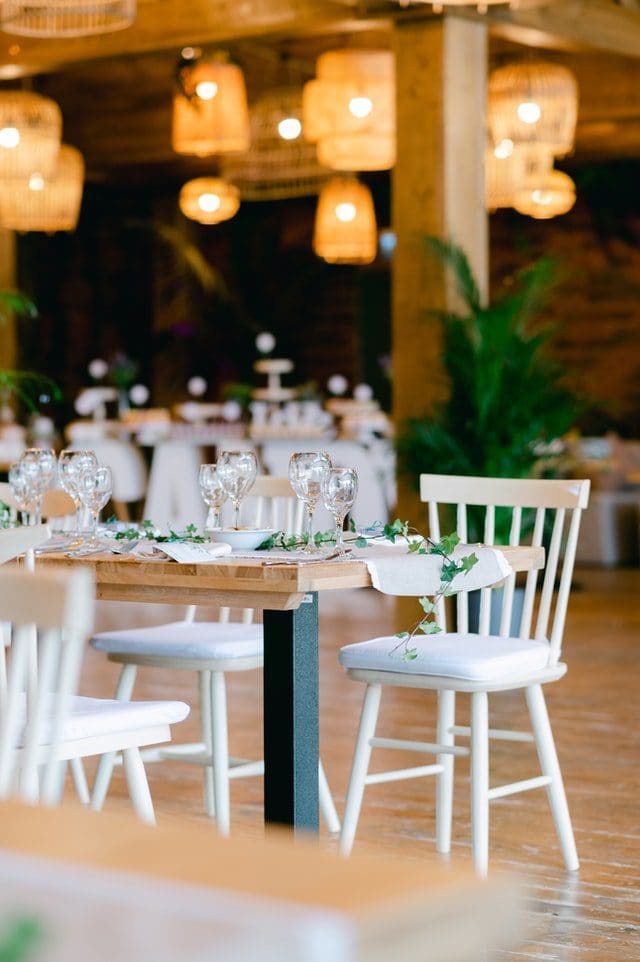 indoor country neutral minimal wedding with white chairs