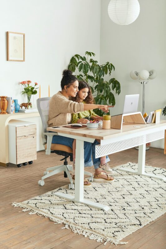 mother daughter sitting at computer natural light