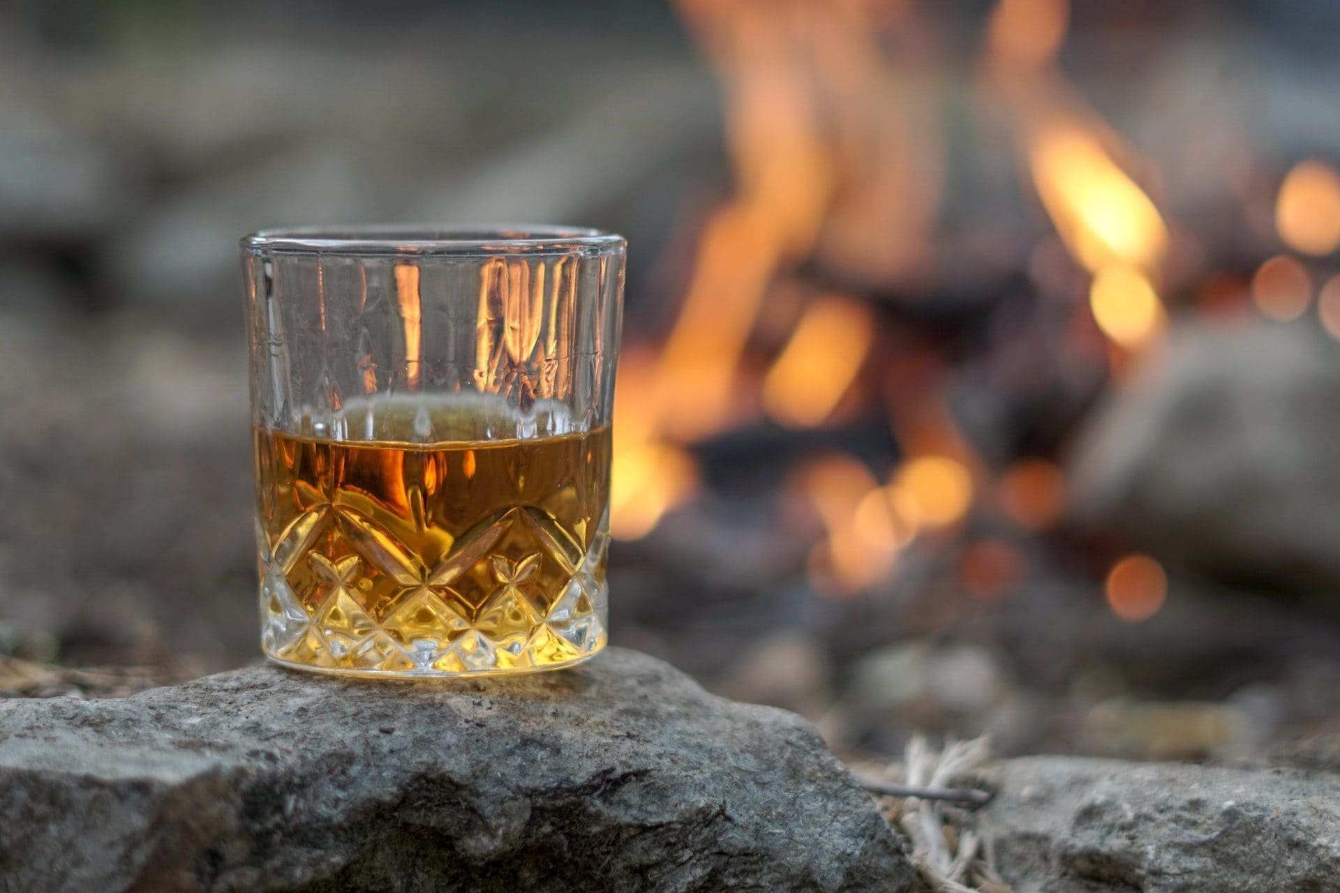 bourbon on rock by the fire roaring
