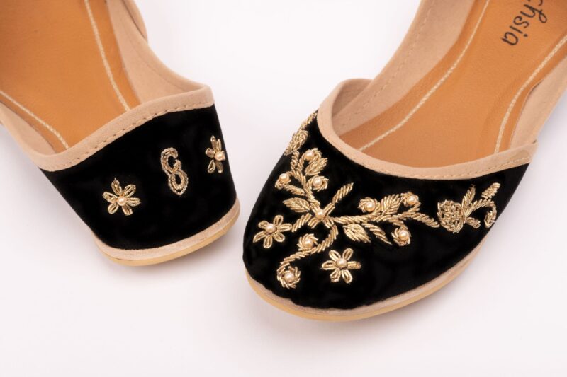 close up of black beaded fuchsia shoes