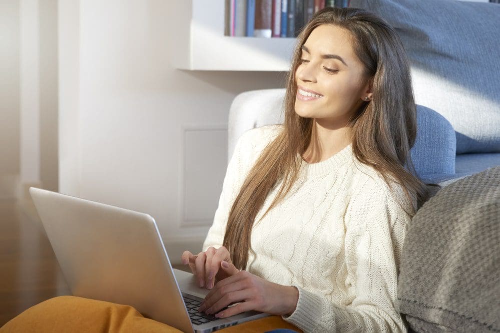 woman with brown hair working on laptop