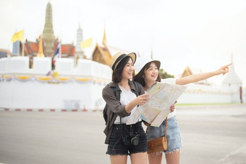 two woman traveling together international tour tours