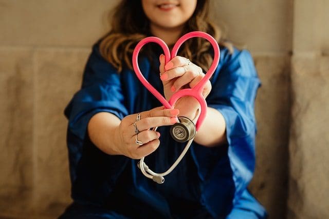 nurse holding stethoscope in heart shape