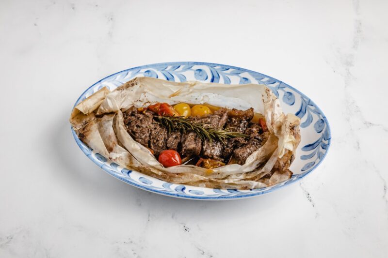 healthy steak dish wrapped in parchment paper