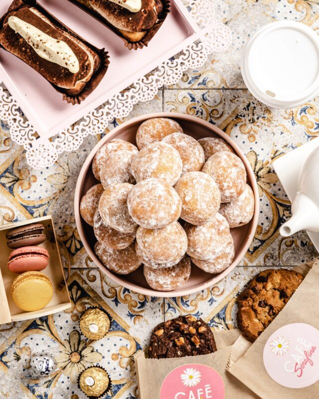 selection of donuts macarons cookies table setting overhead photo