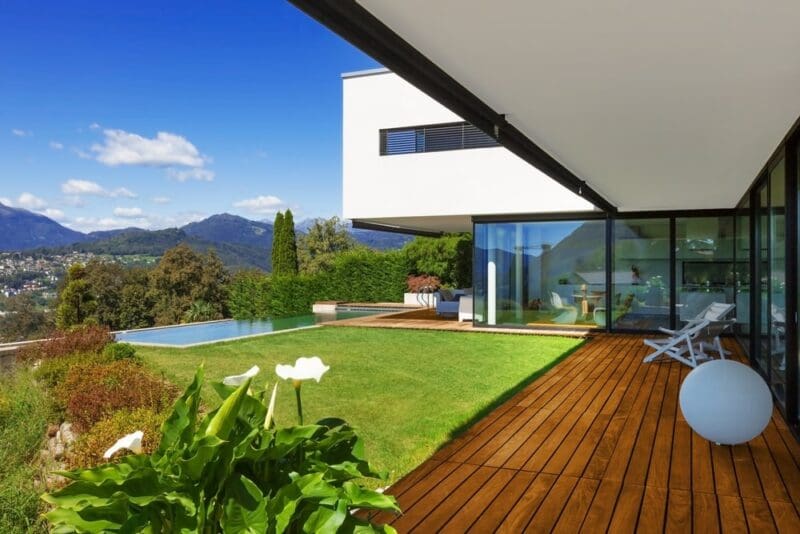 villa with infinity pool green grass wood deck