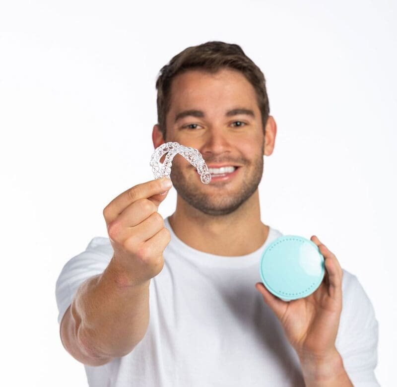 man holding teeth straightener kit