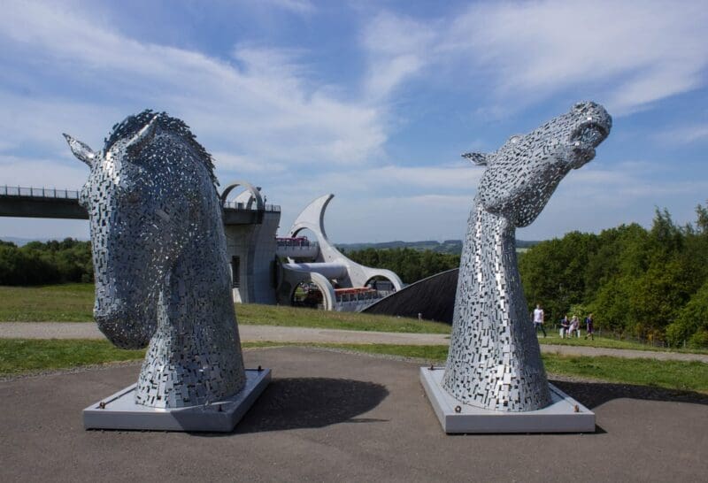 Kelpies Standing on Car Park on Front of Falkirk Wheel Turning Around with Boats