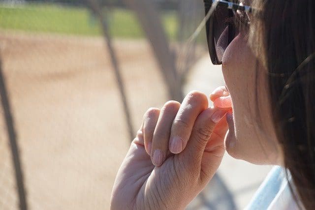 woman eating gummies outside at game