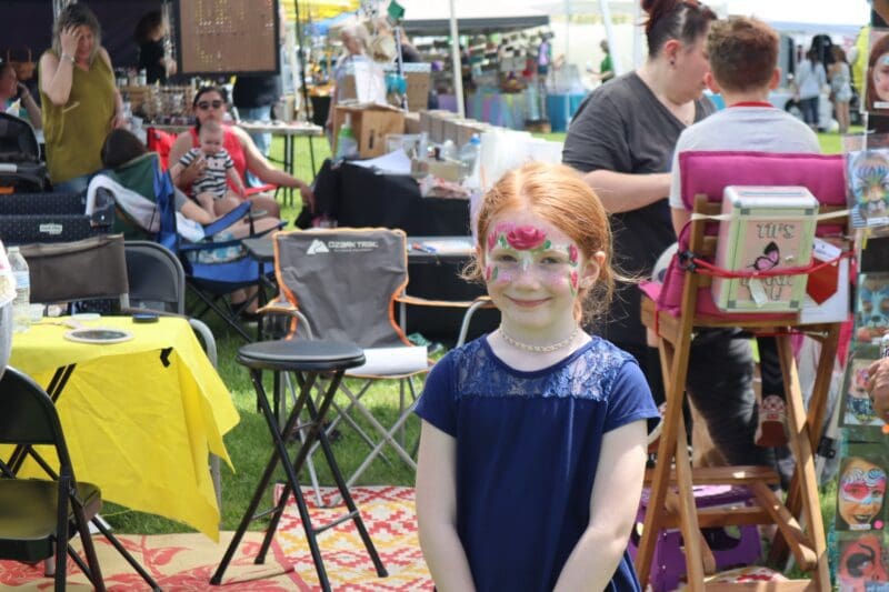face painting red haired girl smiling
