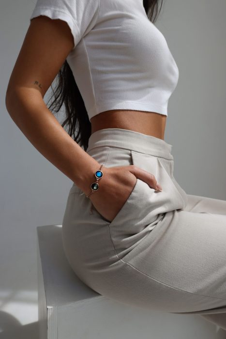 girl with white cropped top wearing bracelet