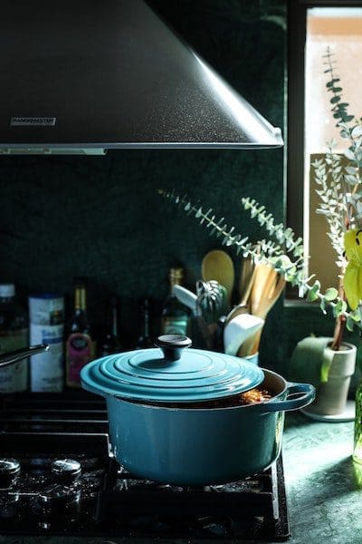 baby blue dutch oven in kitchen stovetop