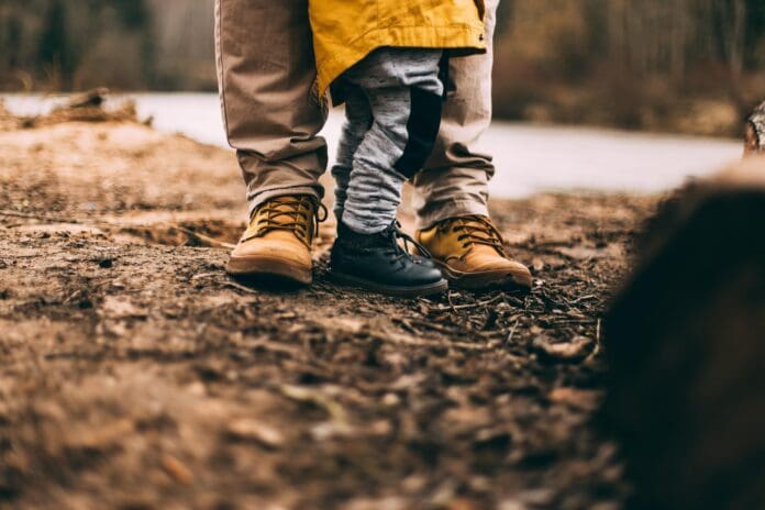 father and child outdoors rugged boots