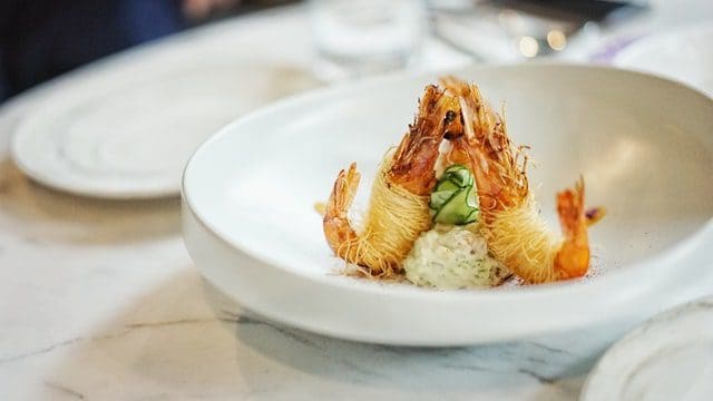 gourmet tempura shrimp dish on white plate