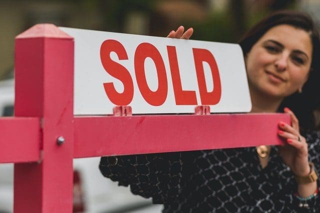 real estate agent holding signage