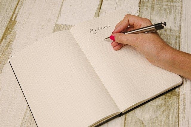 woman working writing in a journal