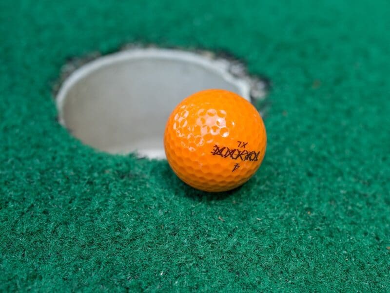 golf ball going in hole