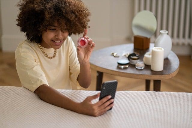 woman with brown hair working on phone