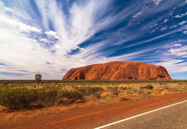 ayers rock blue sky clouds red sand australia