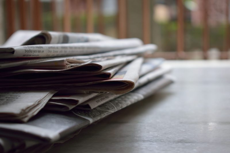 stack of newspapers on table