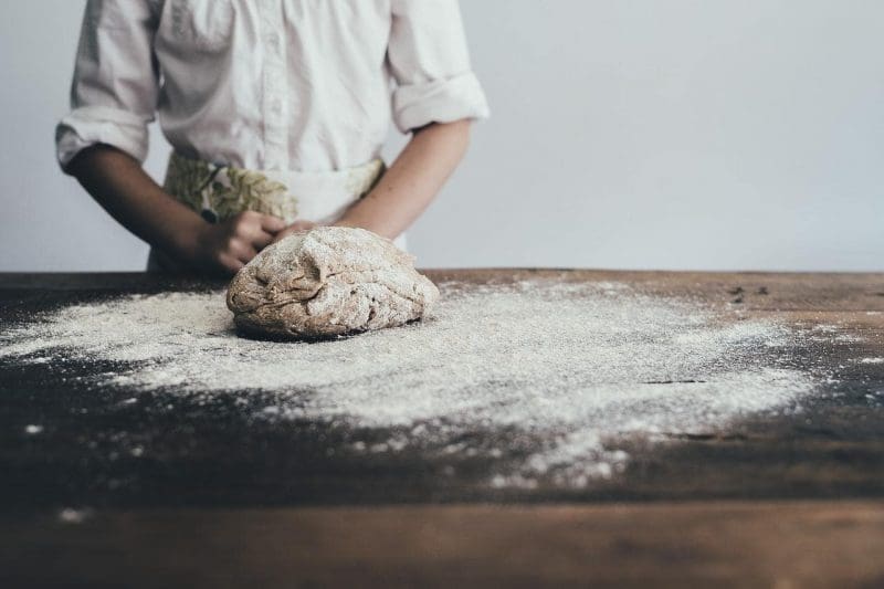 baker in front of bread dough