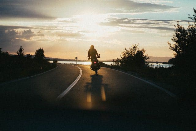 riding a motorcycle into the sunset