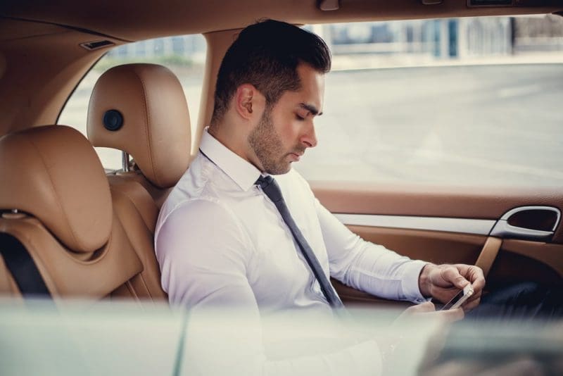 Man in a white shirt using smartphone